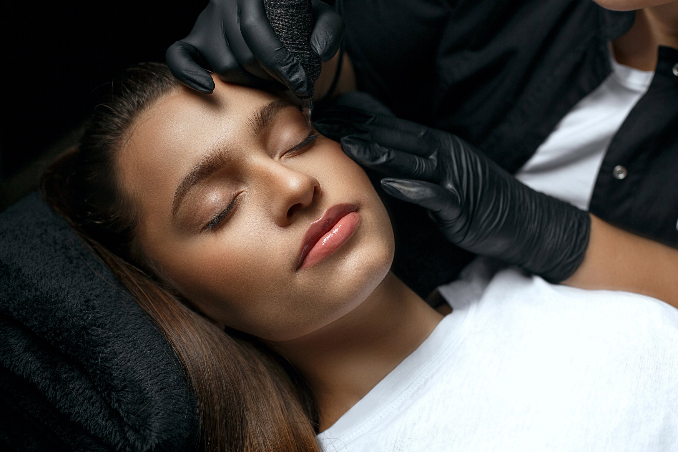 Beauty master making permanent brow makeup